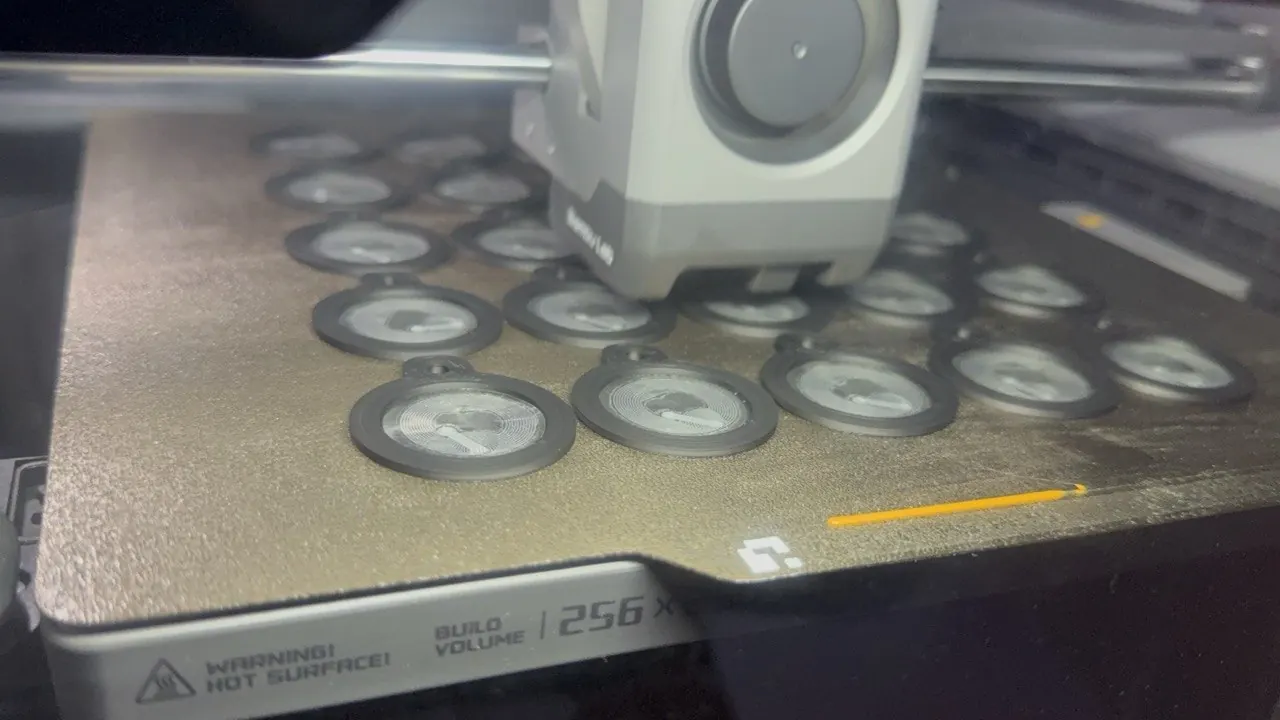 Round NFC tag bodies in the middle of a print on our Bambu Lab printer